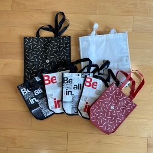 7 red, black, and white small/medium Lululemon totes
